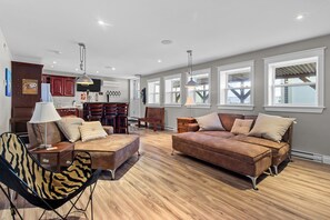 A spacious  living area with modern decor and a wooden floor.