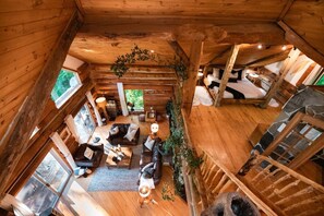 View from the top floor looking down to the King bed loft and main floor sitting area!