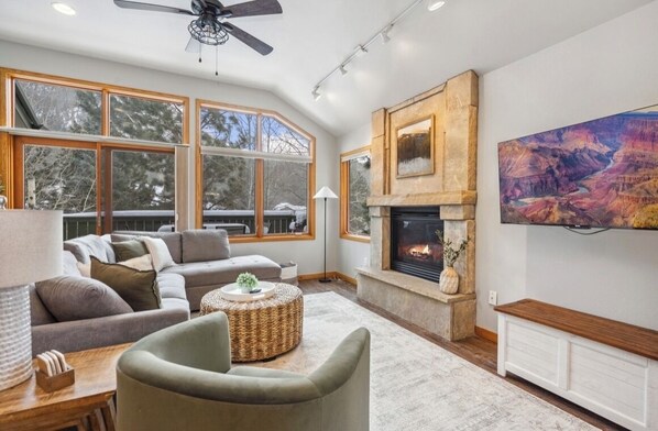 Main level living room with tv.   Deck access off of living room