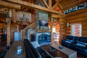 Main living room with fireplace and smart samsung TV with ample seating