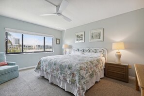Master bedroom with king bed  and soft lighting from window