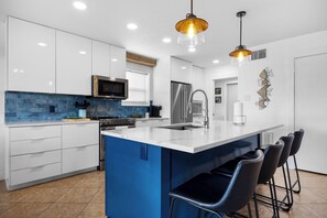 Culinary Haven: Cook up seaside delights in the fully equipped kitchen with modern appliances and plenty of counter space
