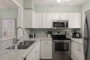 The kitchen is fully equipped and features high end appliances