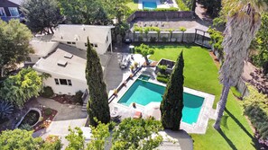 Rental includes expansive fenced-in yard with pool, hot tub & small koi pond. 