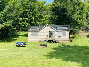 Take the tiny challenge in this hand crafted tiny 240 sq ft cabin.  The cabin is nestled on Brenchly Lake and surrounded by nature.