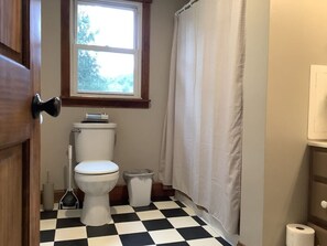 Spacious, updated bathroom equipped with a tub and shower.
