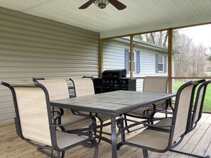 Enjoy the peaceful surroundings on this large, screened in porch fully equipped with a grill.
