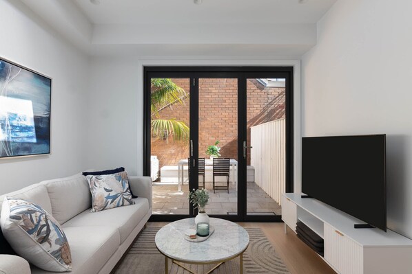 Luxury open plan living space flowing to couryard