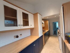 Fully equipped kitchen leading onto the enclosed south facing yard