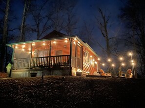 View of cabin and firepit from the road.