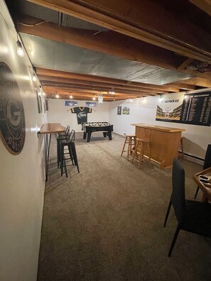 Basement Game room with Foosball,Darts, Poker Table, TV with Fire Stick, and Bar