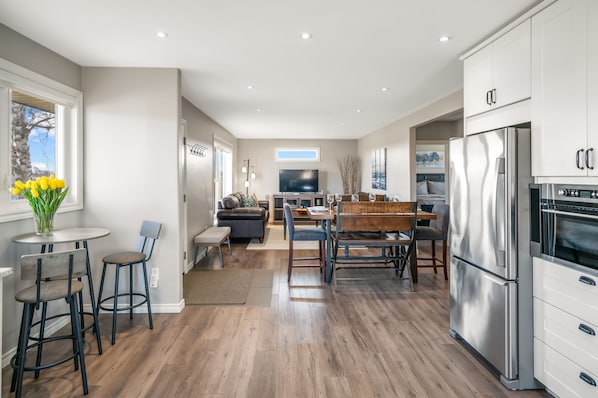 Open concept kitchen, living and dining area with streaming TV 