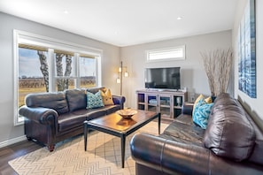 Open concept kitchen, living and dining area with streaming TV