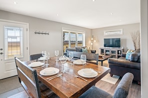Open concept kitchen, living and dining area with streaming TV
