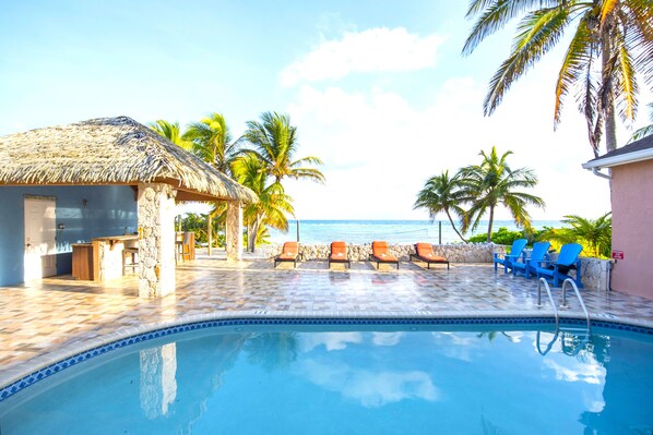 Enjoy the gorgeous, beachfront swimming pool with it's spacious deck and cabana.
