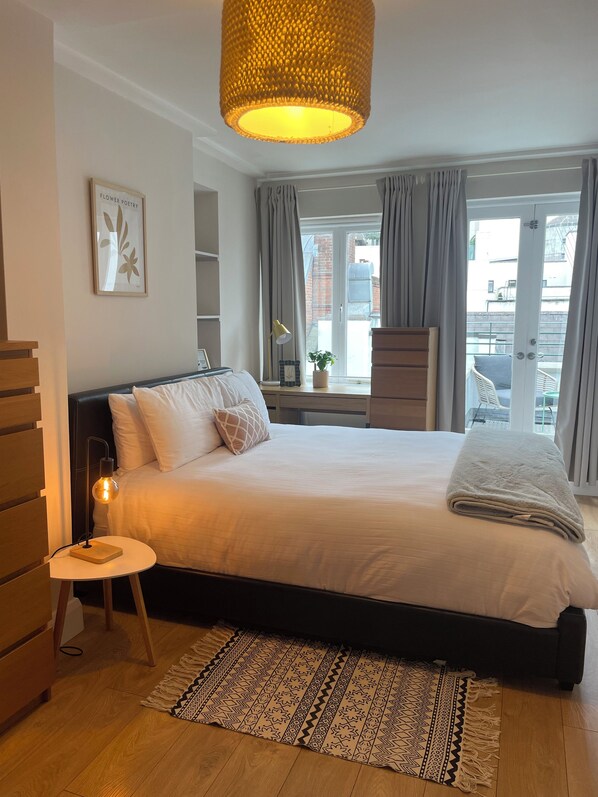 Main Bedroom with king sized bed and access to balcony