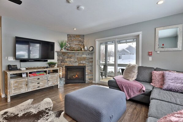 Enjoy our comfy living area, complete with a cozy gas fireplace and smart TV. Relax on our spacious sofa or take in the fresh air outside, just through the sliding door.