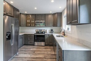 Cook like a pro in the upgraded kitchen—stainless steel appliances, large island, bar seating, forest views, and all the cookware you’ll need.