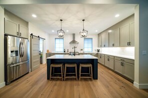 The spacious gourmet kitchen is outfitted with all top-of-the-line stainless steel appliance.