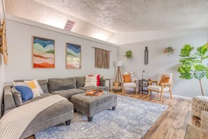 The stylish and charming living room comes outfitted with a large comfy sectional sofa, chairs, puzzles, and games, and a large Smart TV, making it the perfect setting to gather with loved ones for quality time.