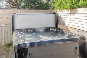 Enjoy a private, new 6-person hot tub with waterfall features and vibrant LED lighting.