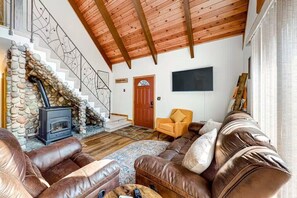 A charming interior greets you where plush furnishings offer a comfortable place to relax while you warm up by the pellet-burning stove.
