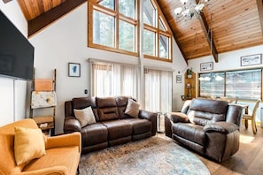 Soaring windows fill the home with natural light and beautiful views over the surrounding nature.
