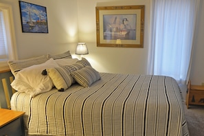 Comfy queen bed in the bedroom.