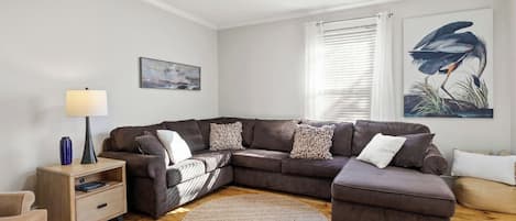 Unwind in our spacious living room with plush seating and chic artwork—ideal for relaxation. A perfect blend of comfort and style.