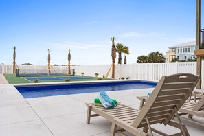 Backyard oasis features a 29' in-ground saltwater pool and pickleball court
