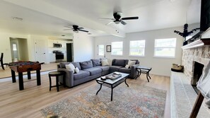Living Room, w/ TV, fireplace, Big couch, and foosball table.
