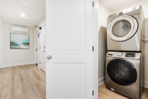 2 washer and dryer sets in the corridor for guests use. Picture is of one set.