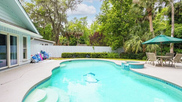 Private swimming pool with a light blue interior and a tiled border