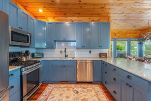 Well-equipped kitchen with dishwasher, kettle, and drip-style coffee maker