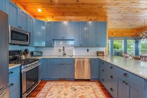 Well-equipped kitchen with dishwasher, kettle, and drip-style coffee maker