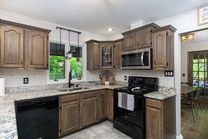 Kitchen with dishwasher, coffee grinder, and 2 types of coffee makers (Keurig & Drip).