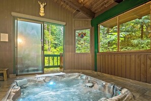 Soak in the private hot tub, tucked discreetly for a serene outdoor experience.
