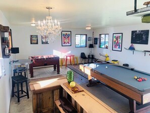 Detached clubhouse features a pool table, foosball table, and wet bar—perfect for entertainment and socializing during your stay.