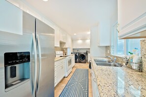 Full size kitchen with refrigerator, stove, oven, microwave