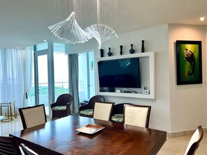 Dining table, tv set and view
