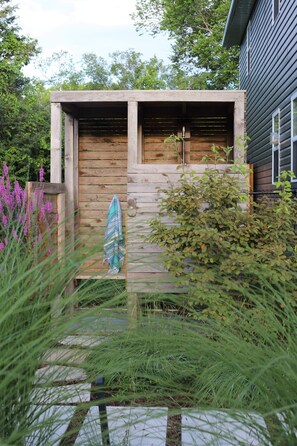 The Private Backyard Outdoor Oasis features a Large Swimming Pool, Hot Tub + Private Outdoor Shower