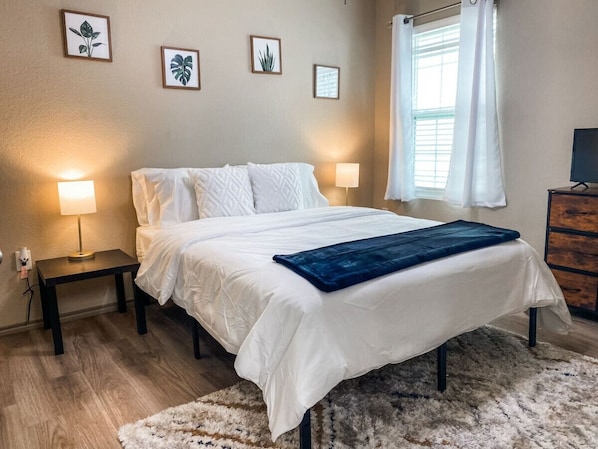 Bedroom with Queen size bed, storage dresser and closet to put luggage or belongings