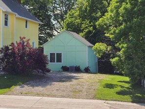 Stay Cottage is located south of the Okoboji Dough Company. You can park in this gravel drive or in the large parking lot to the south. You can bring your lawn chairs out closer to the road if you want to enjoy the traffic and the people! 