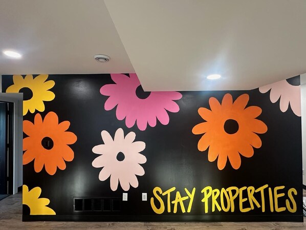 We just added the fun wall in Jones Beach Suite in Spring of 2025. The other pictures still show the white wall but expect this fun upon arrival! 