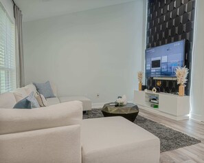 "Our living room features a comfortable sectional sofa and a large TV."

