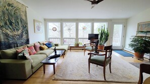 Living room with comfortable seating and door to deck