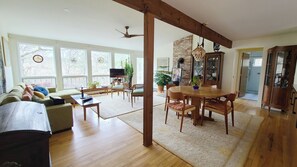 Open and bright main living area with large windows and vaulted ceiling