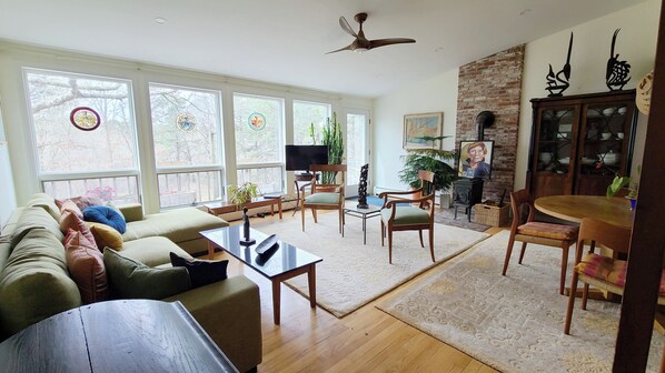 Open and bright main living area with large windows and vaulted ceiling