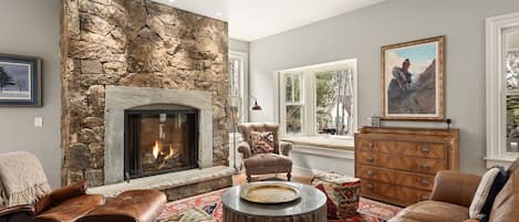 Open concept living room with large gas fireplace and plush furnishings