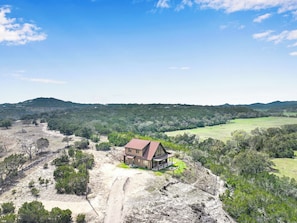 The Log Home at Lighthouse Ranch is situated atop one of the Hill Country's rolling hills